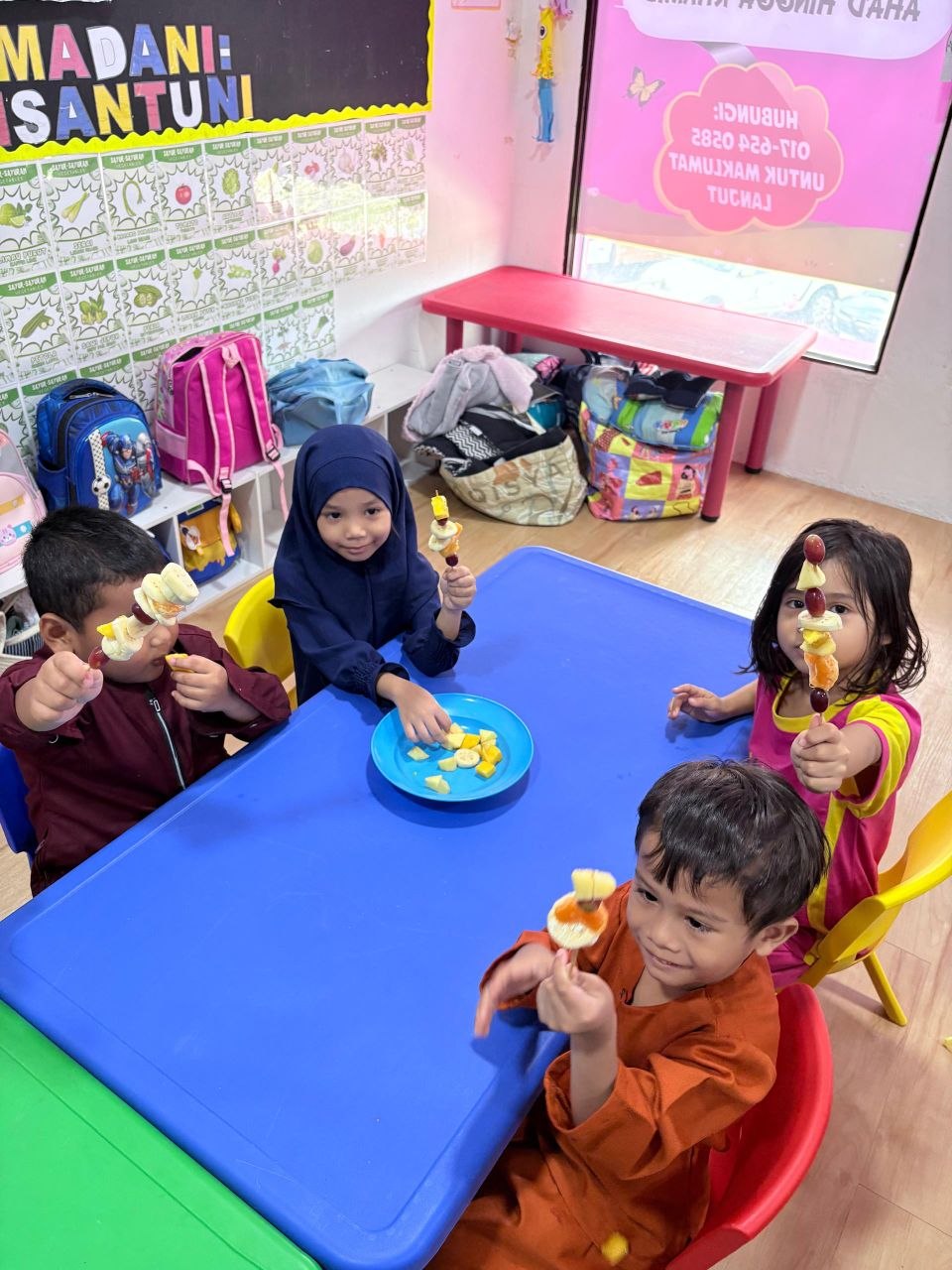 Children enjoying afternoon snack at Little Darwisy